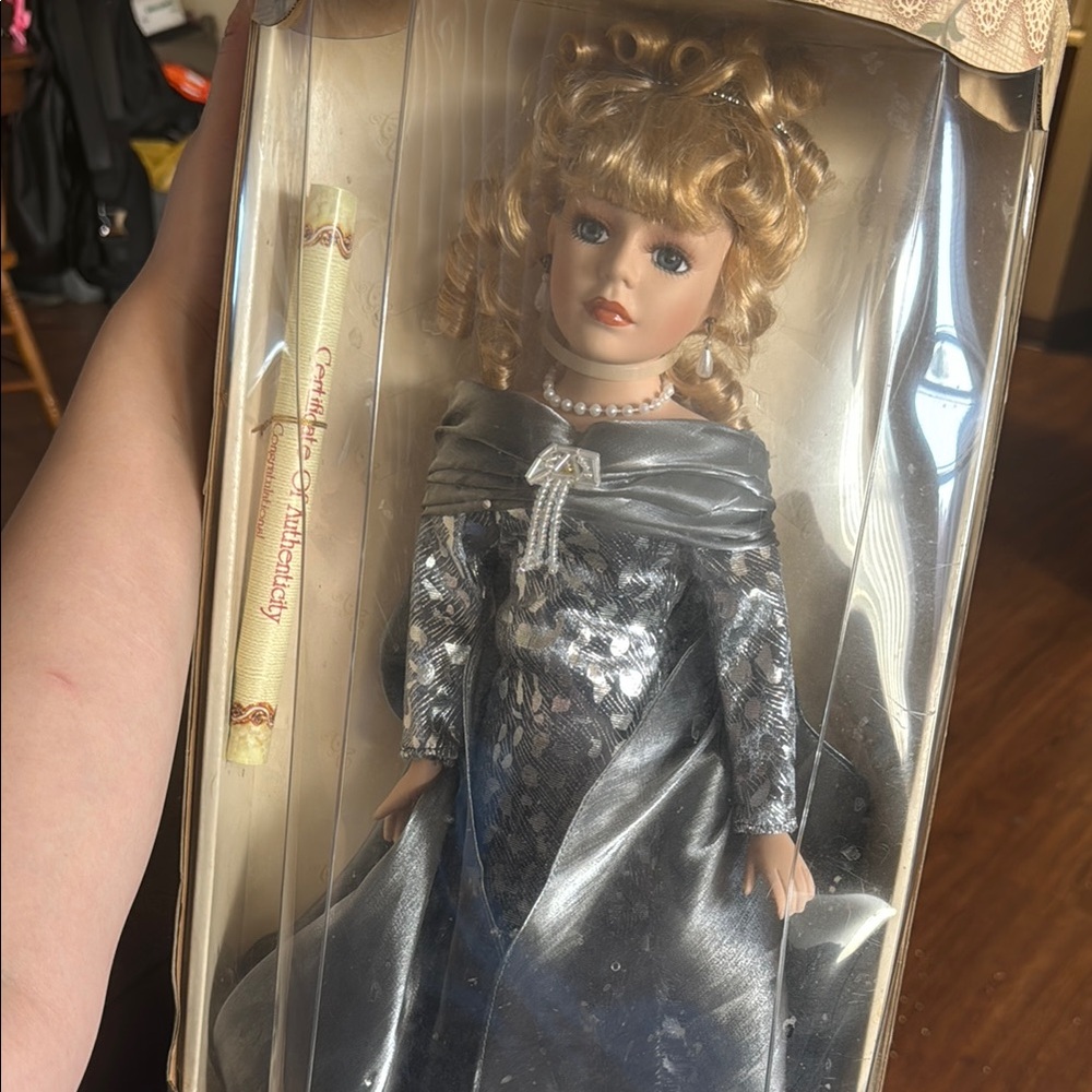 Elegant Doll with Silver Dress and Blonde Curls